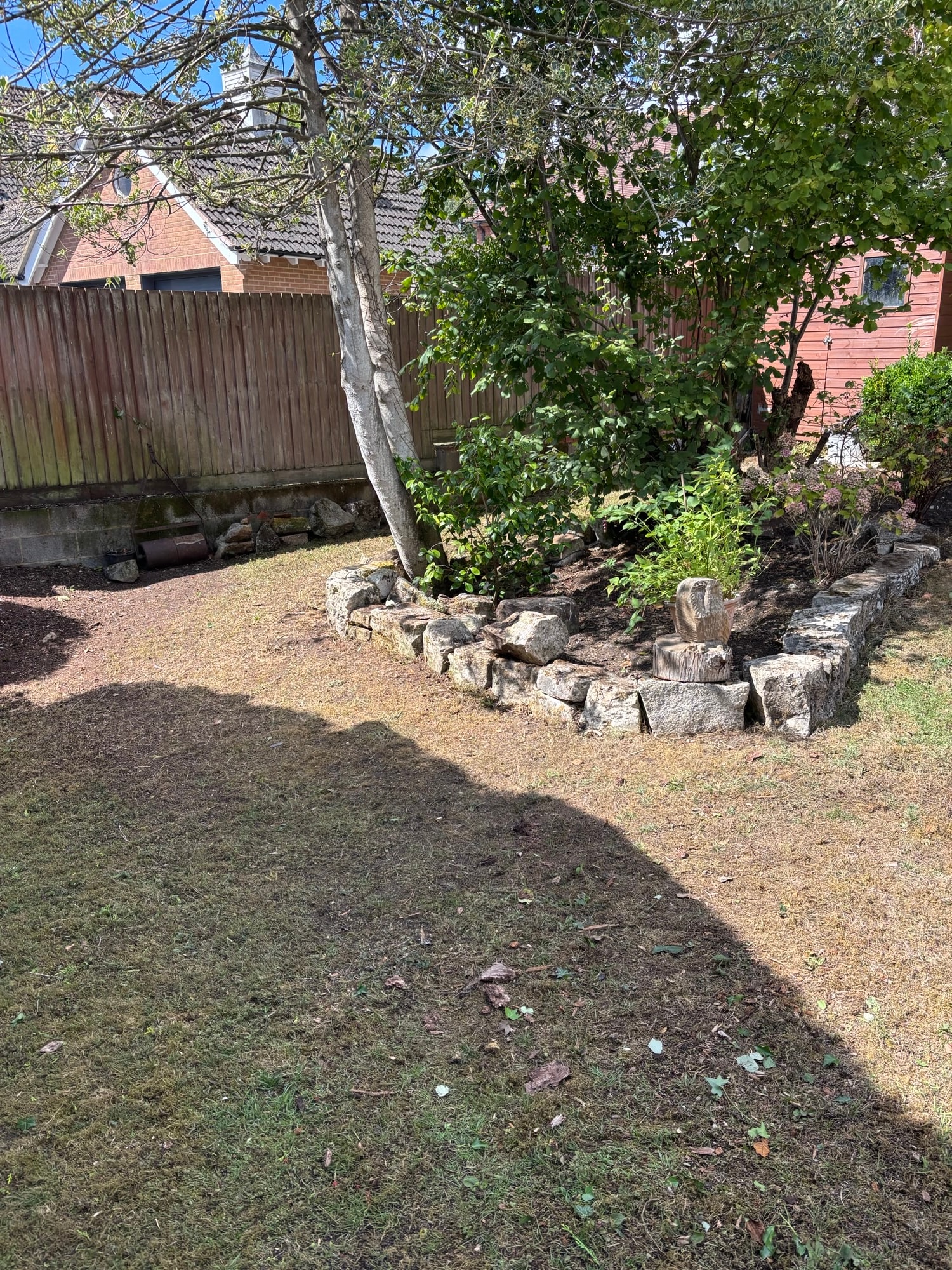 Cleared garden after Open Ground clearance — stone wall area tidied